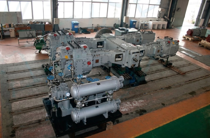 Detailed view of a multi-stage high-pressure oil-free compressor demonstrating the extreme heavy-wall intercoolers and 4-stage cylinder configuration