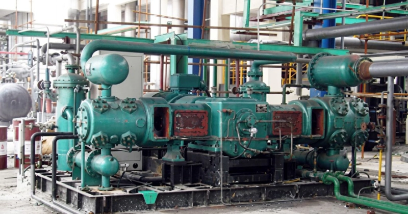 Detailed view of a multi-stage oil-free high-pressure hydrogen compressor demonstrating the precise heavy-wall cylinder layout and high-pressure piping