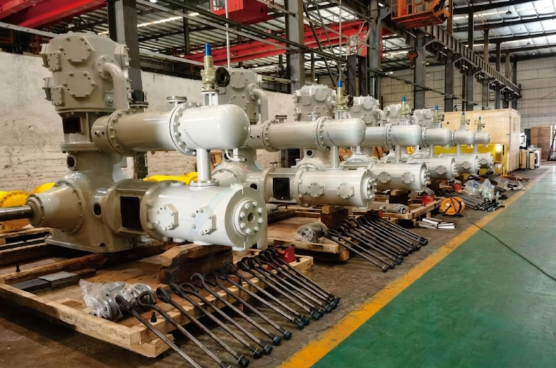 Close up view of the LW-9/8.7-29 booster compressor showing intricate water cooling jackets and heavy-duty frame