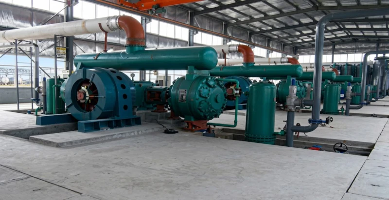 Massive shell-and-tube water cooling heat exchangers attached to the low-pressure oil-free compressor